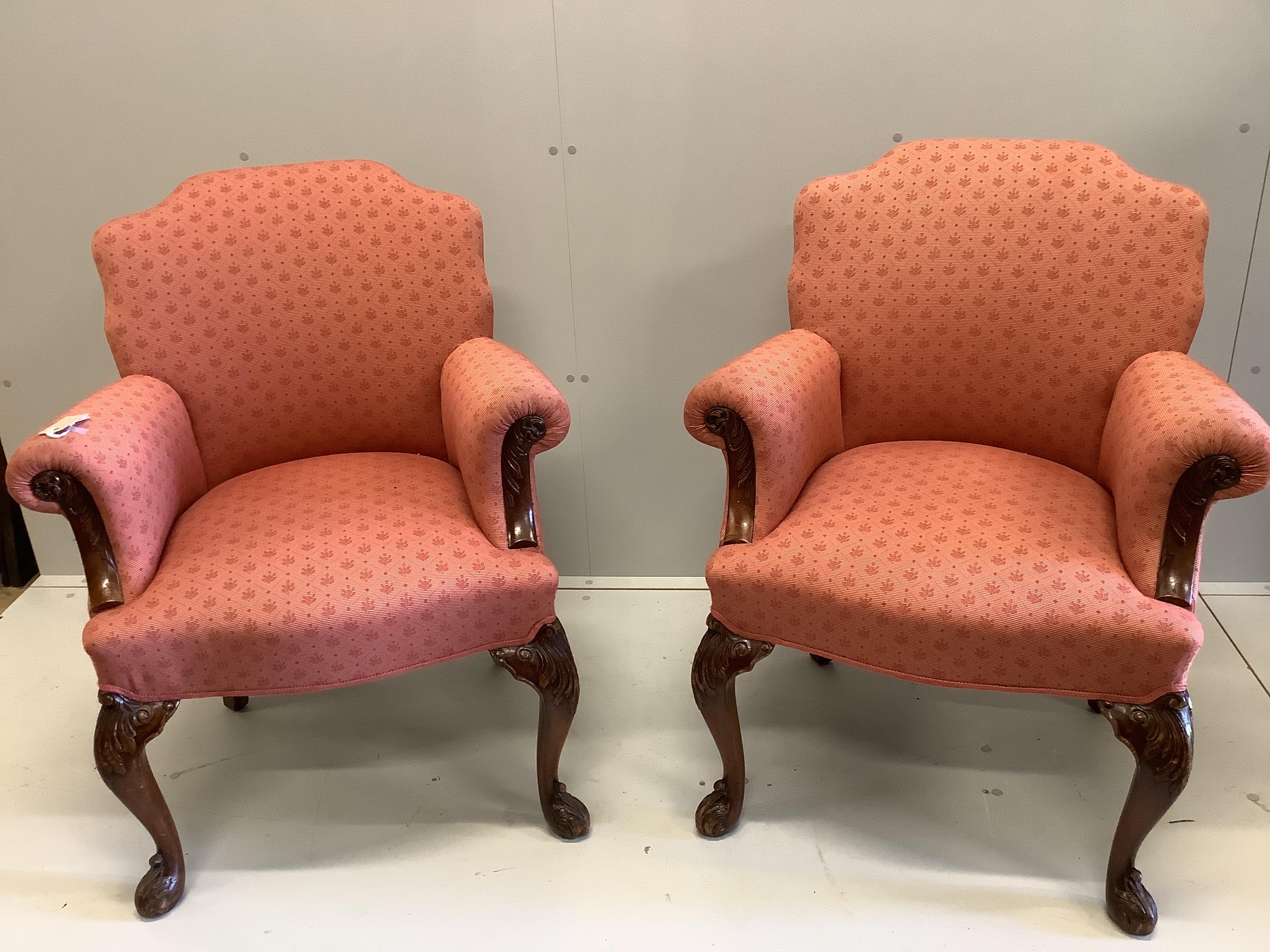 A pair of George II style upholstered scroll armchairs, width 72cm, depth 60cm, height 91cm